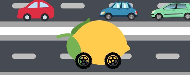 cars going down the road in one direction and then a car that is in the shape of a lemon going down the road in another direction